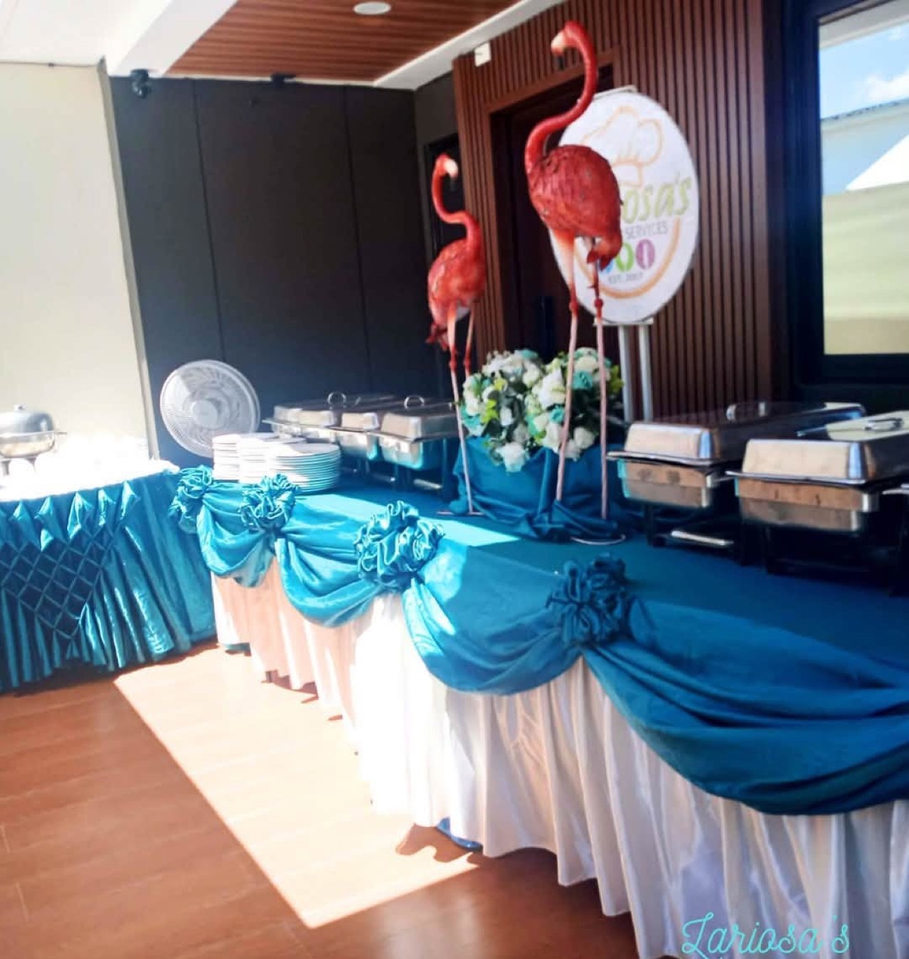 A real teal buffet station with flamingo styling